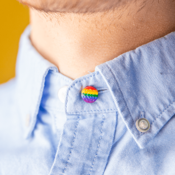 front view of a man wearing an LGBTQ+ shirt collar extender